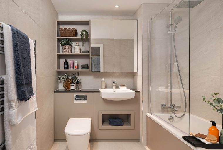 A bathroom with a toilet, sink, and bathtub with a shower.