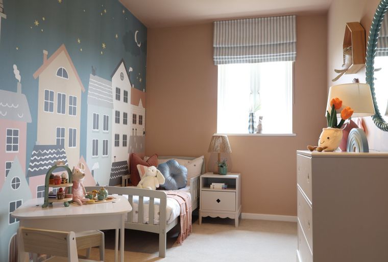 A child's bedroom with a mural, bed, and dresser.