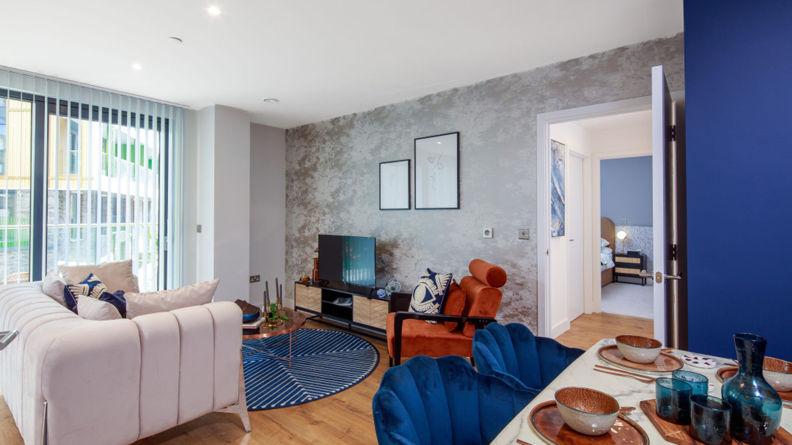 A living room and dining area with a sofa, accent chair, and dining table.