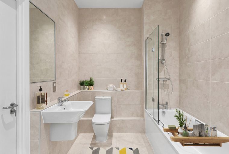 A bathroom with a sink, toilet, and bathtub with a shower.
