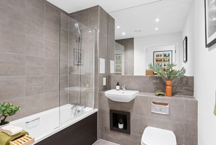 A bathroom with a bathtub, sink, and toilet.