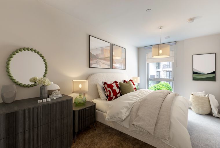 A bedroom with a bed, bedside tables, a dresser, and artwork.