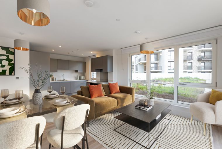A living room and dining area with a sofa, chairs, and a dining table.