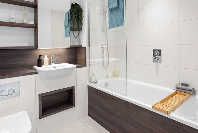 A bathroom with a sink, toilet, and bathtub.