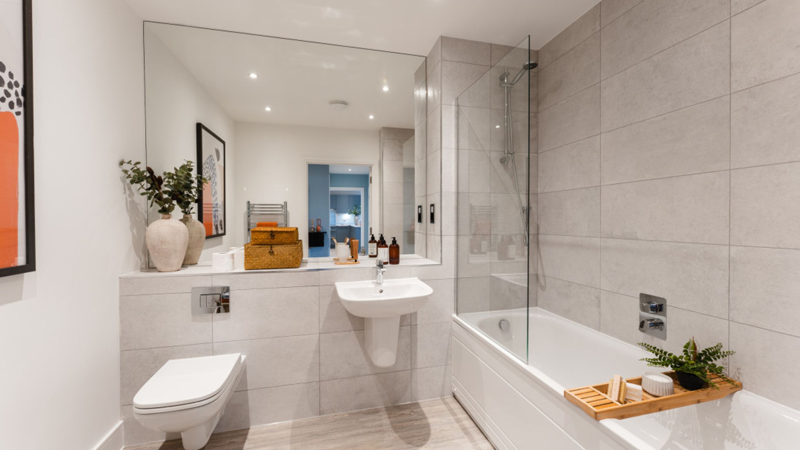 A modern bathroom with a toilet, sink, and bathtub.