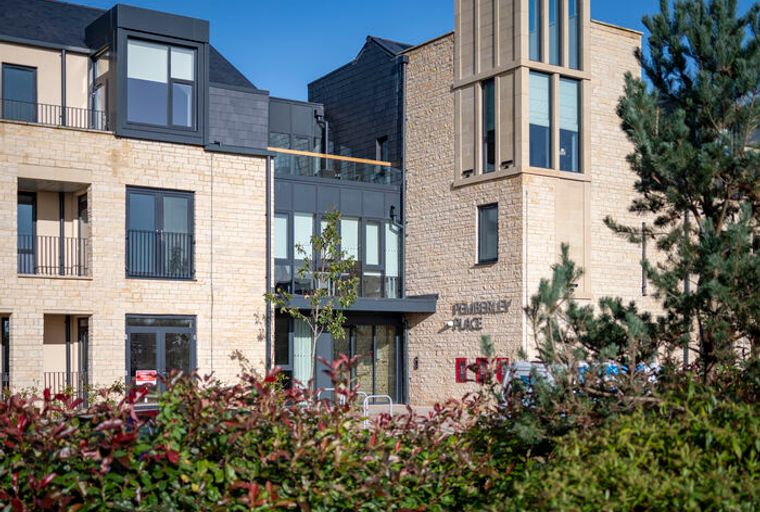 A modern building with stone facades and balconies, labeled 'PEMBERLEY PLACE'.