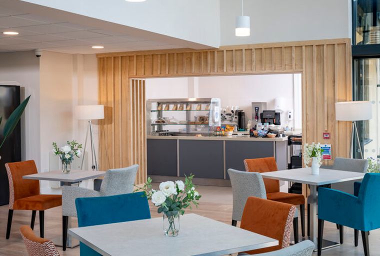 A cafe area with tables and chairs.