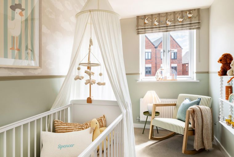 A nursery with a crib, rocking chair, and shelves filled with toys.