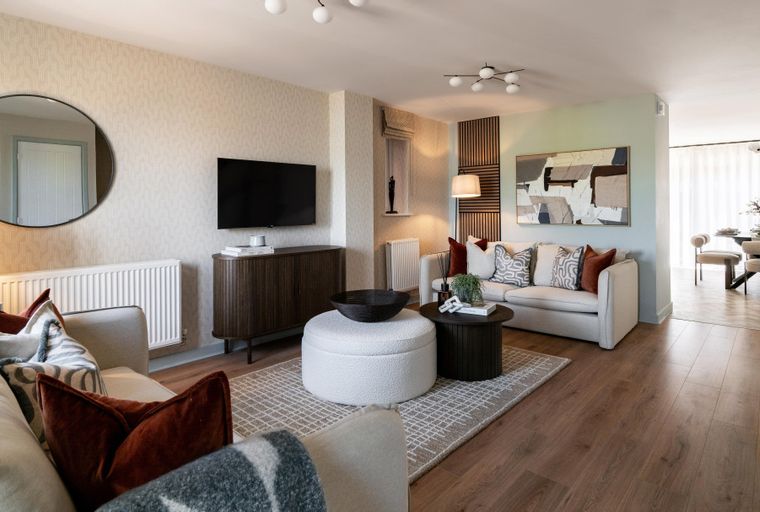 A living room with a sofa, accent chair, coffee table, and ottoman.