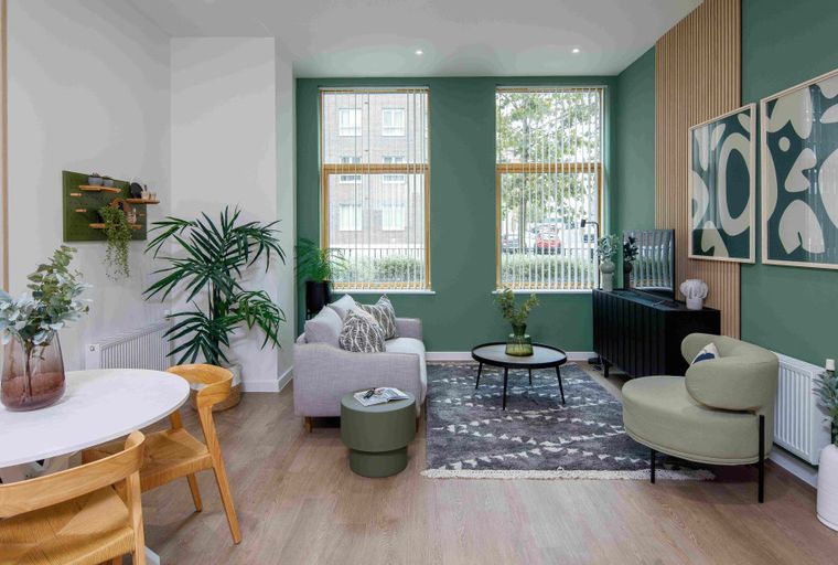 A living room and dining area with a sofa, coffee table, dining table, and chairs.