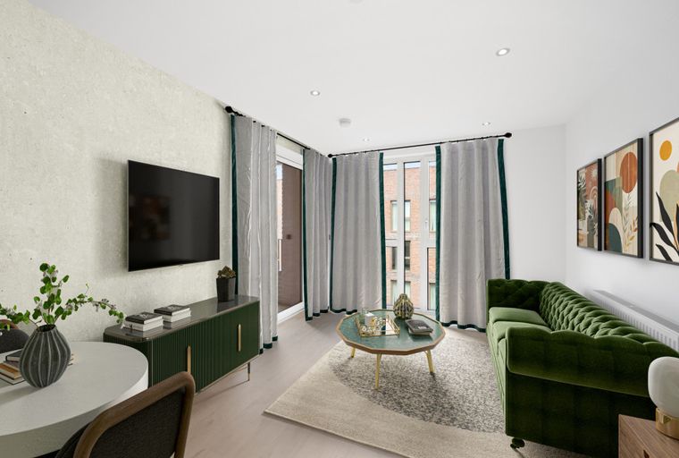 A living room with a green sofa, coffee table, and a TV.