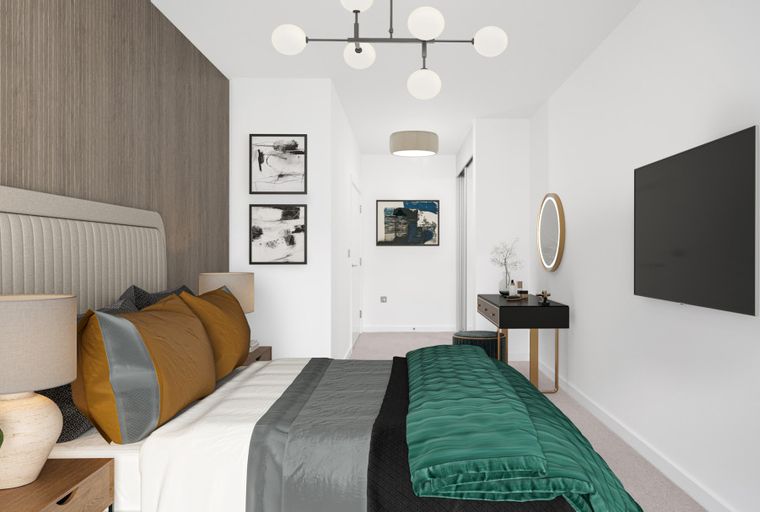 A bedroom with a bed, lamps, artwork, a vanity, and a television.