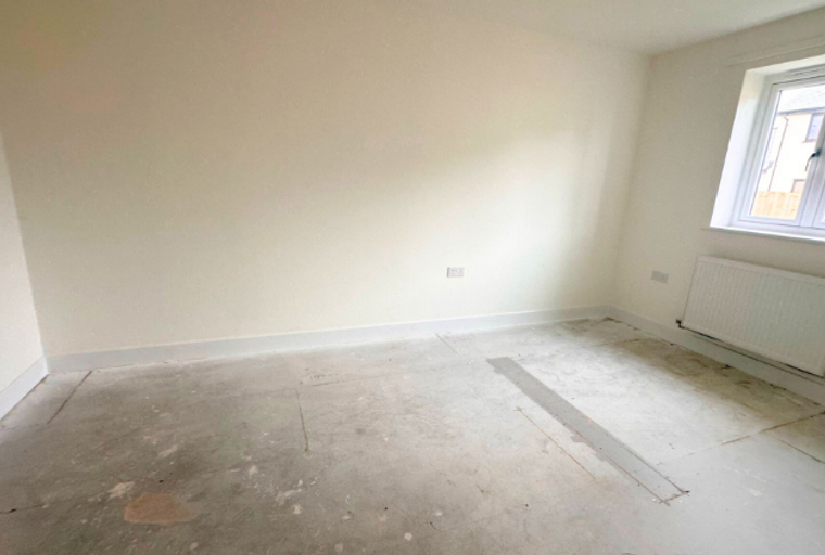 A room with a window and a radiator.