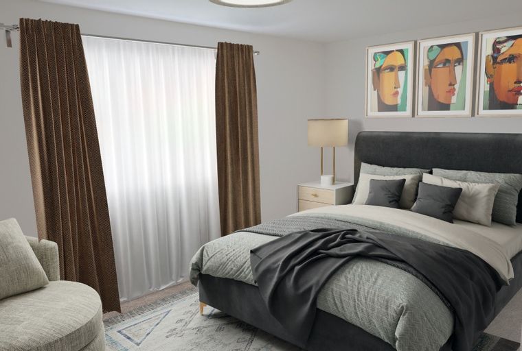 A bedroom with a bed, pillows, curtains, and artwork.