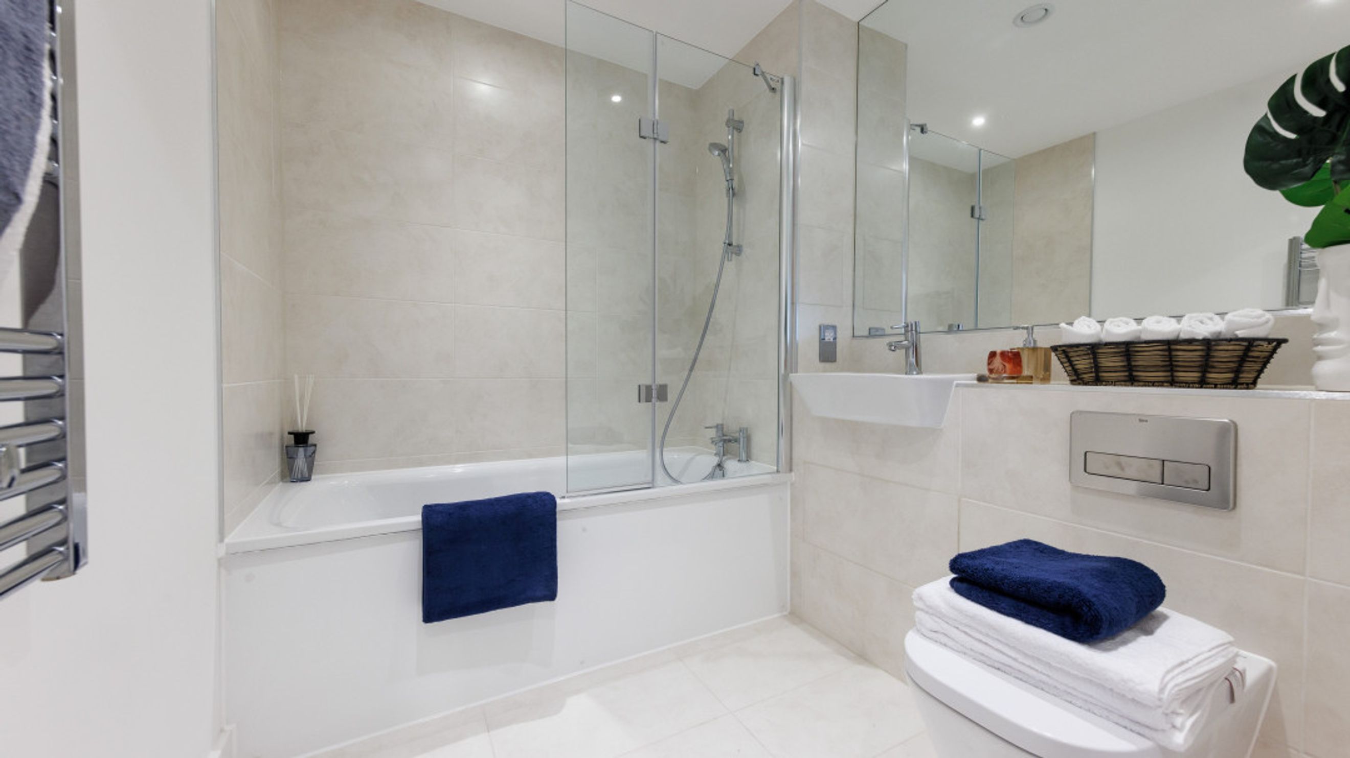A bathroom with a bathtub, shower, sink, and toilet.