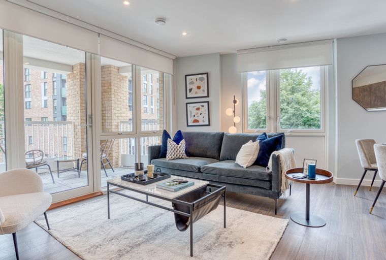 A living room with a sofa, coffee table, and chairs.