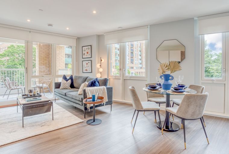 A living and dining area with a sofa, coffee table, and dining set.
