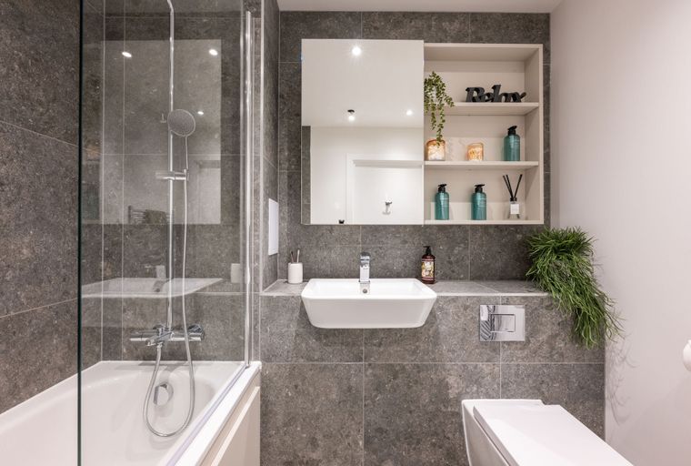 A bathroom with a bathtub, shower, sink, and toilet.
