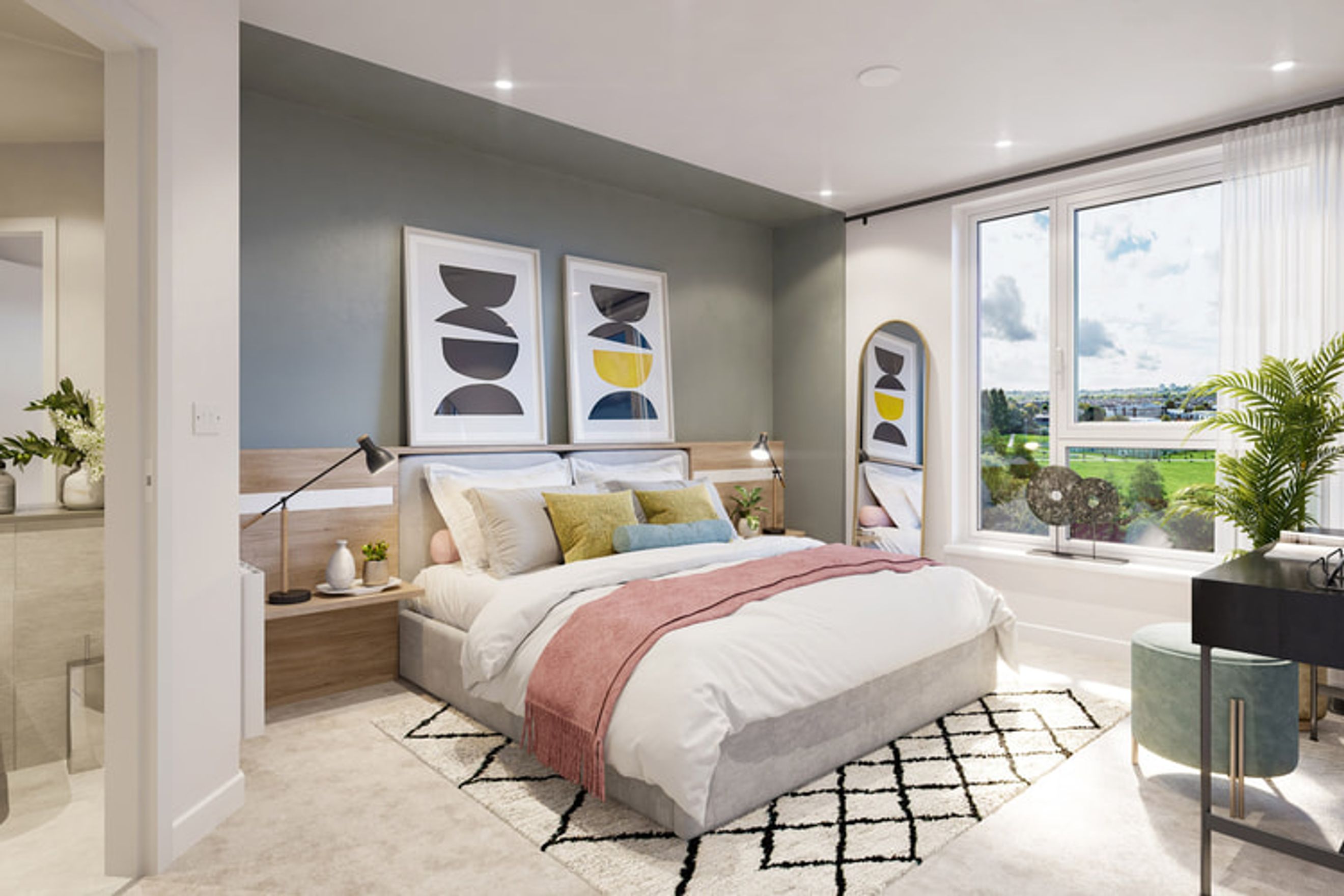 A bedroom with a bed, bedside tables, artwork, and a large window.