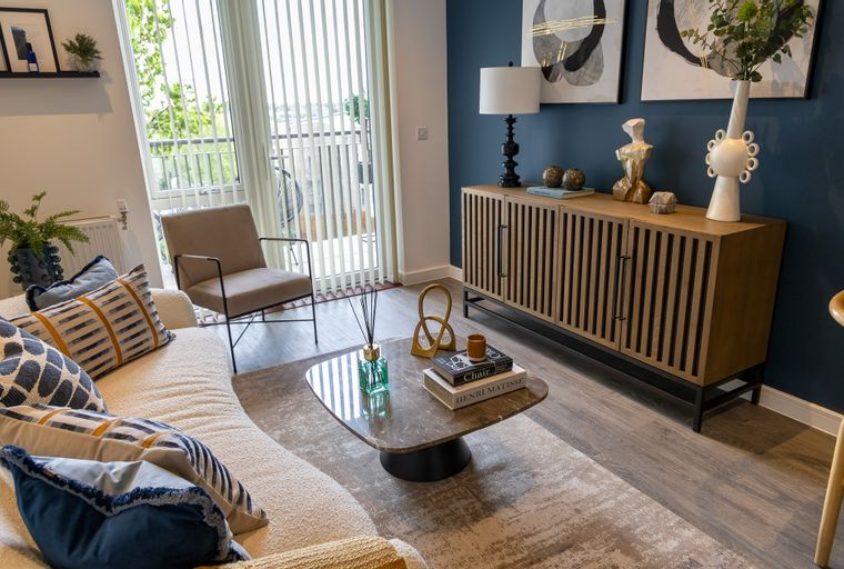 A living room with a sofa, coffee table, and a cabinet.
