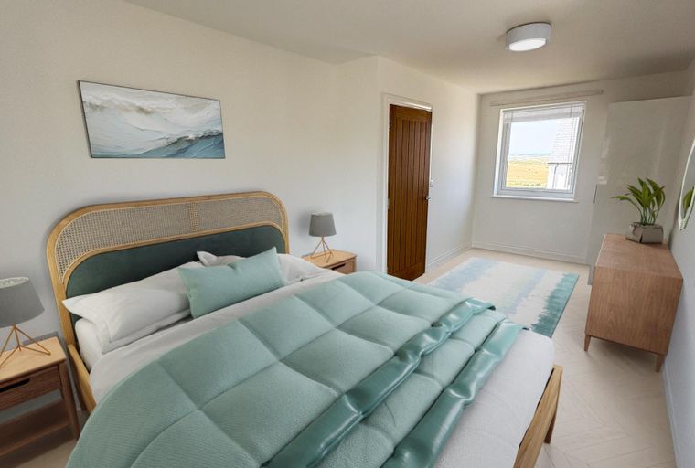 A bedroom with a bed, nightstands, a dresser, and a window.