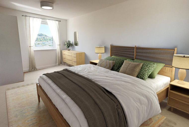 A bedroom with a bed, nightstands, and a dresser.
