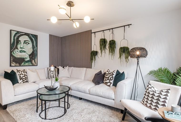 A living room with a sectional sofa, armchair, coffee table, and floor lamp.