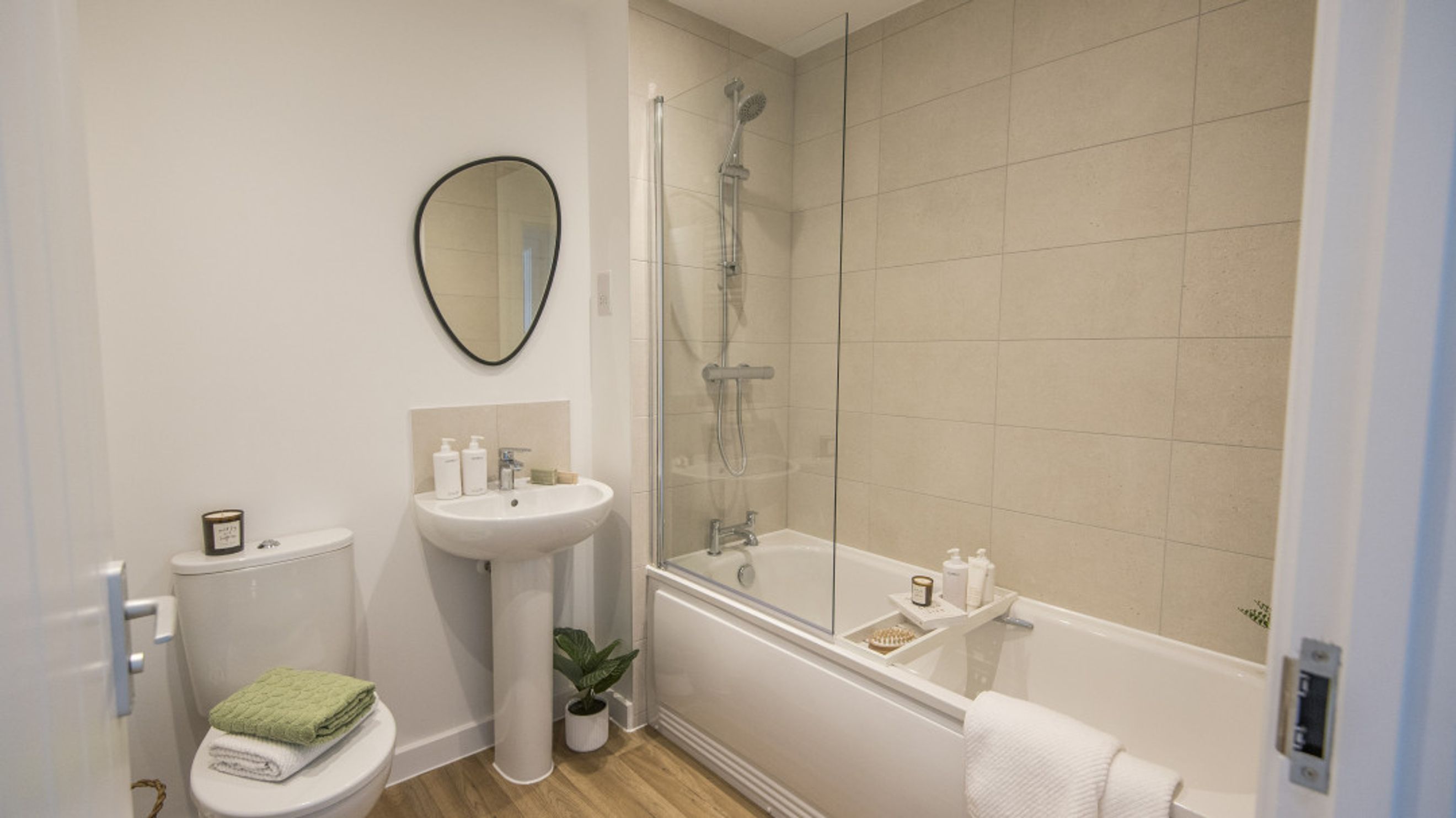 A bathroom with a toilet, sink, and bathtub with a shower.