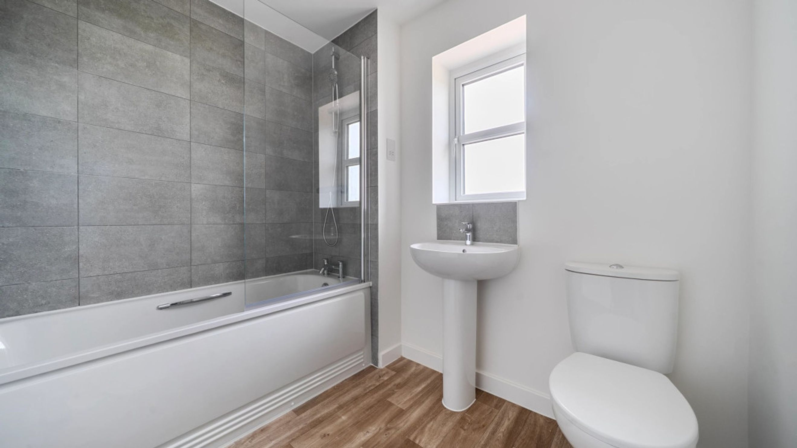 A bathroom with a bathtub, a sink, and a toilet.