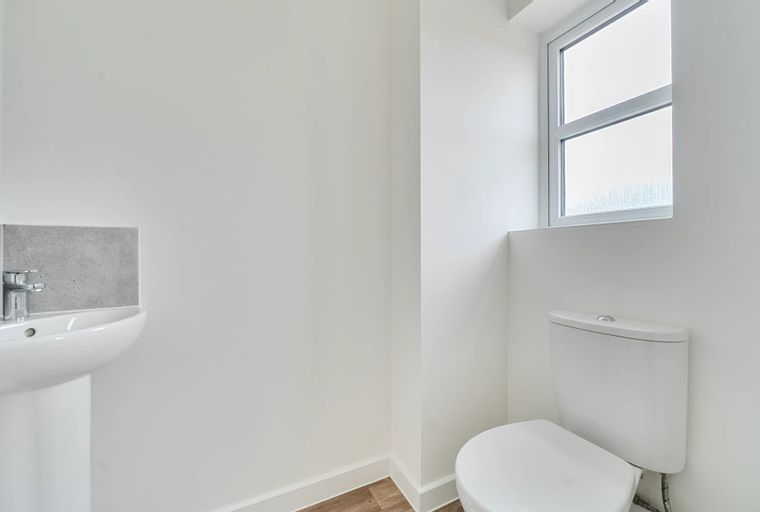 A bathroom with a sink and a toilet.