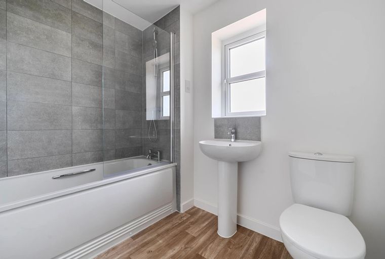 A bathroom with a bathtub, a sink, and a toilet.