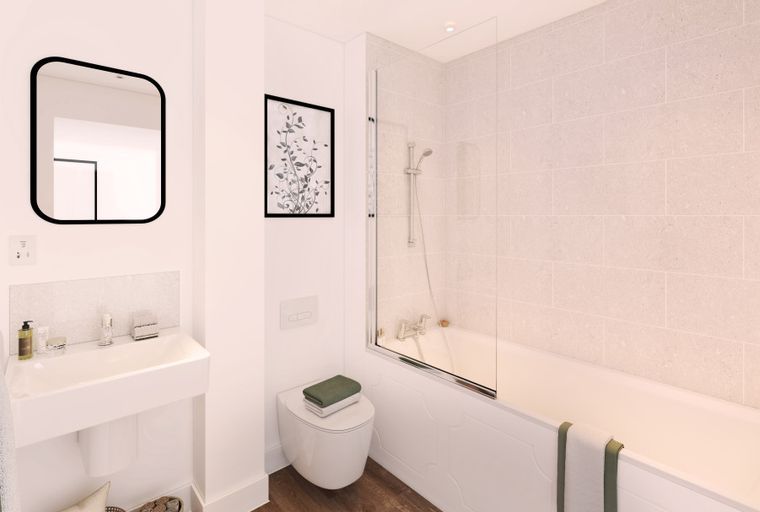 A bathroom with a sink, mirror, toilet, and bathtub.