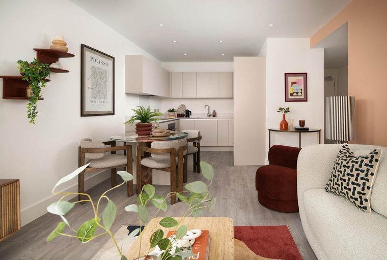 A living room and kitchen area with a dining table.