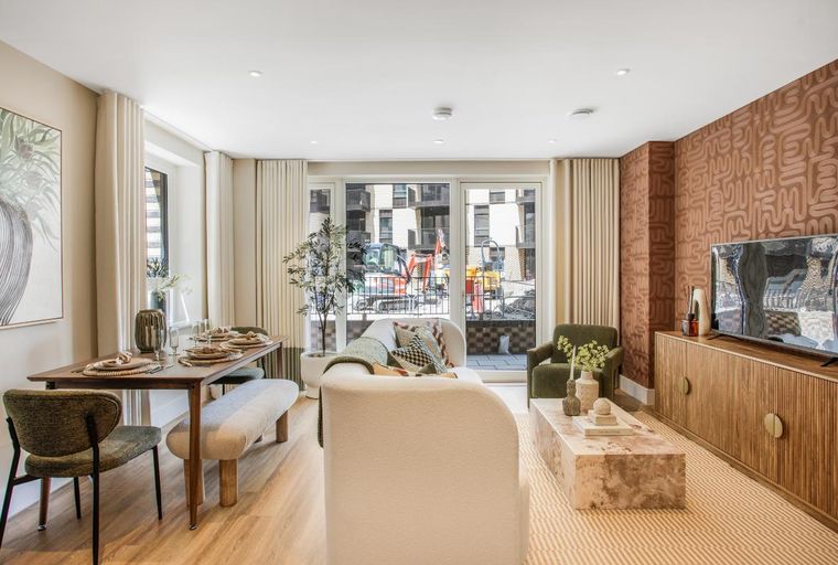 A living and dining room with a dining table, chairs, a sofa, a coffee table, and a TV stand.