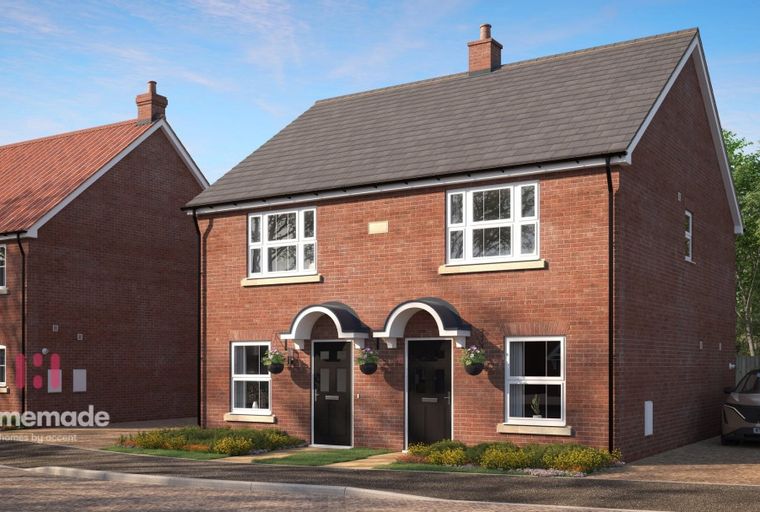A pair of red brick semi-detached houses with arched doorways and white-framed windows.