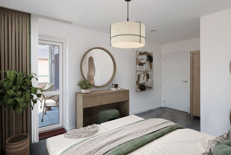 A bedroom with a bed, a dressing table, a round mirror, and curtains.