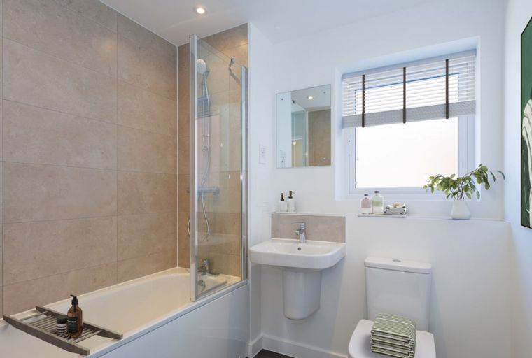 A bathroom with a bathtub, shower, sink, and toilet.