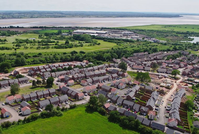 An aerial view of a residential neighborhood with many houses and some construction.