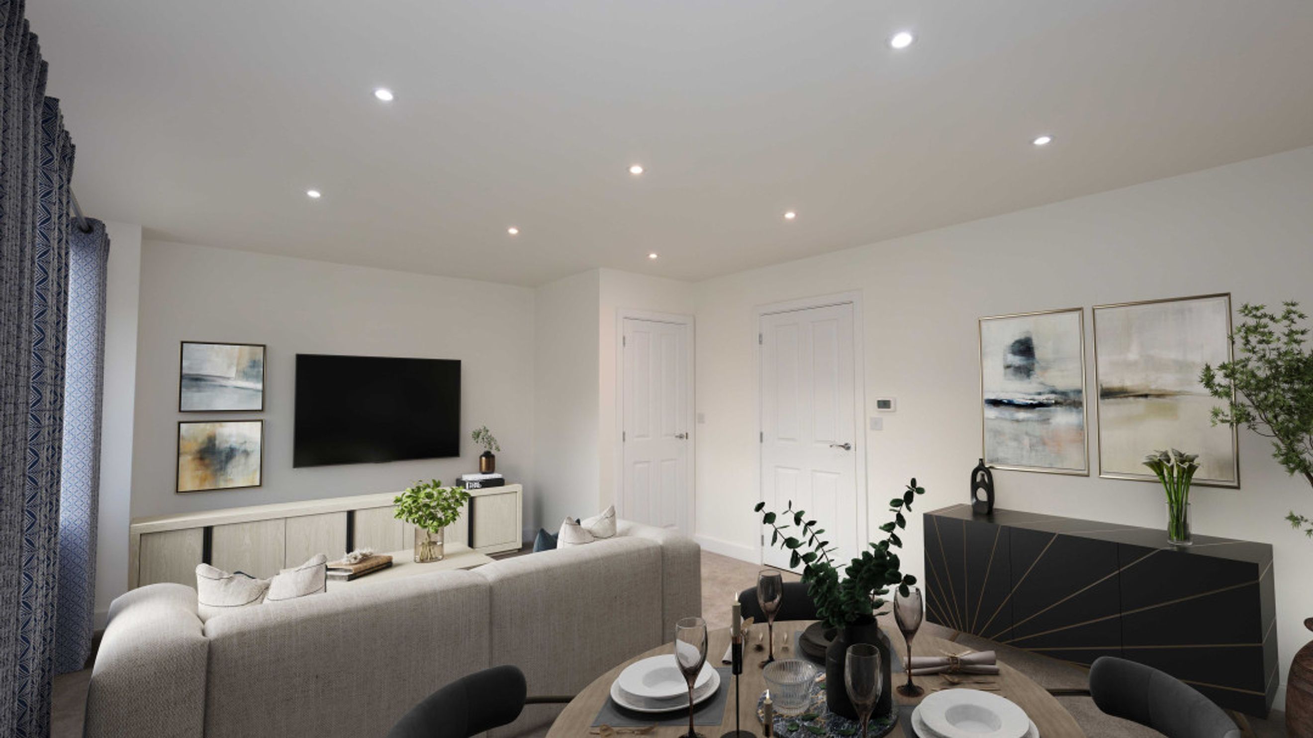 A living and dining room with a sofa, TV, dining table, and artwork.