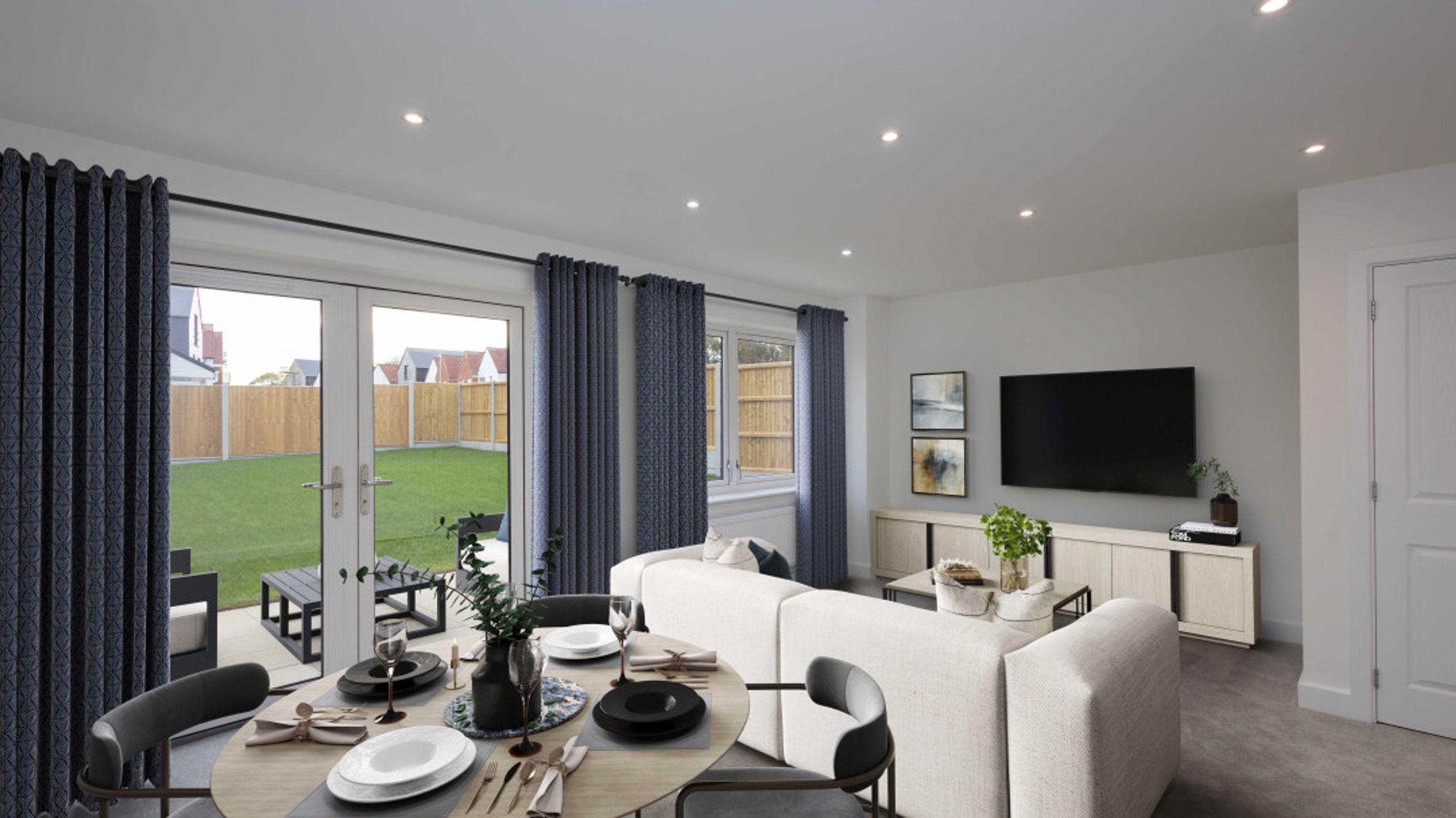 A dining area and living room with French doors opening to a garden.