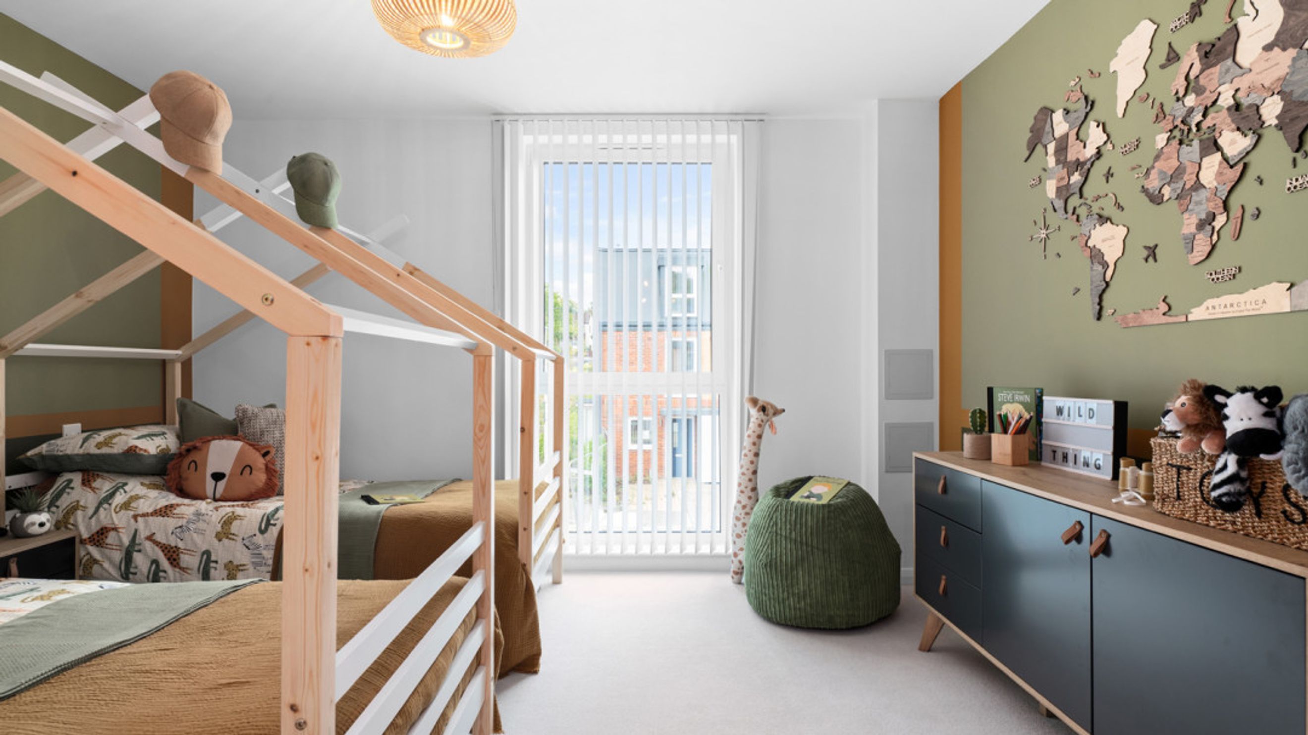 A children's bedroom with two beds, a world map, and a dresser.