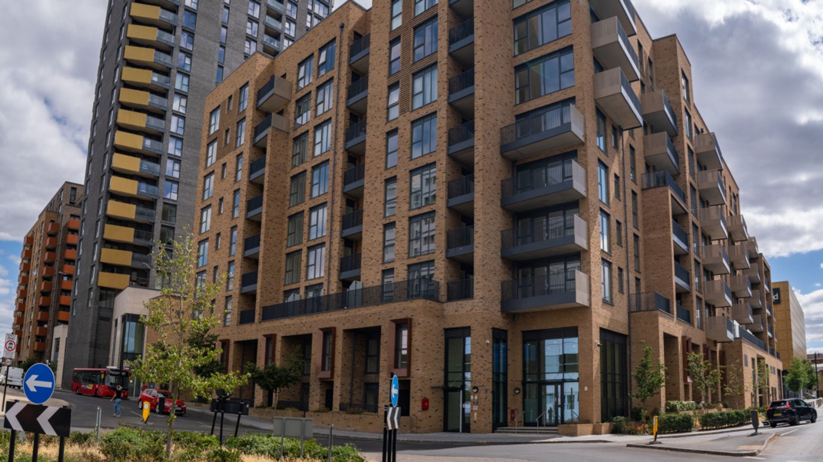 A modern apartment building with a brick facade and balconies.