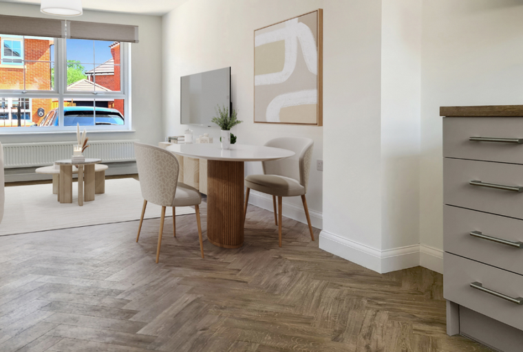 A dining area with a round table and chairs next to a sofa and coffee table.