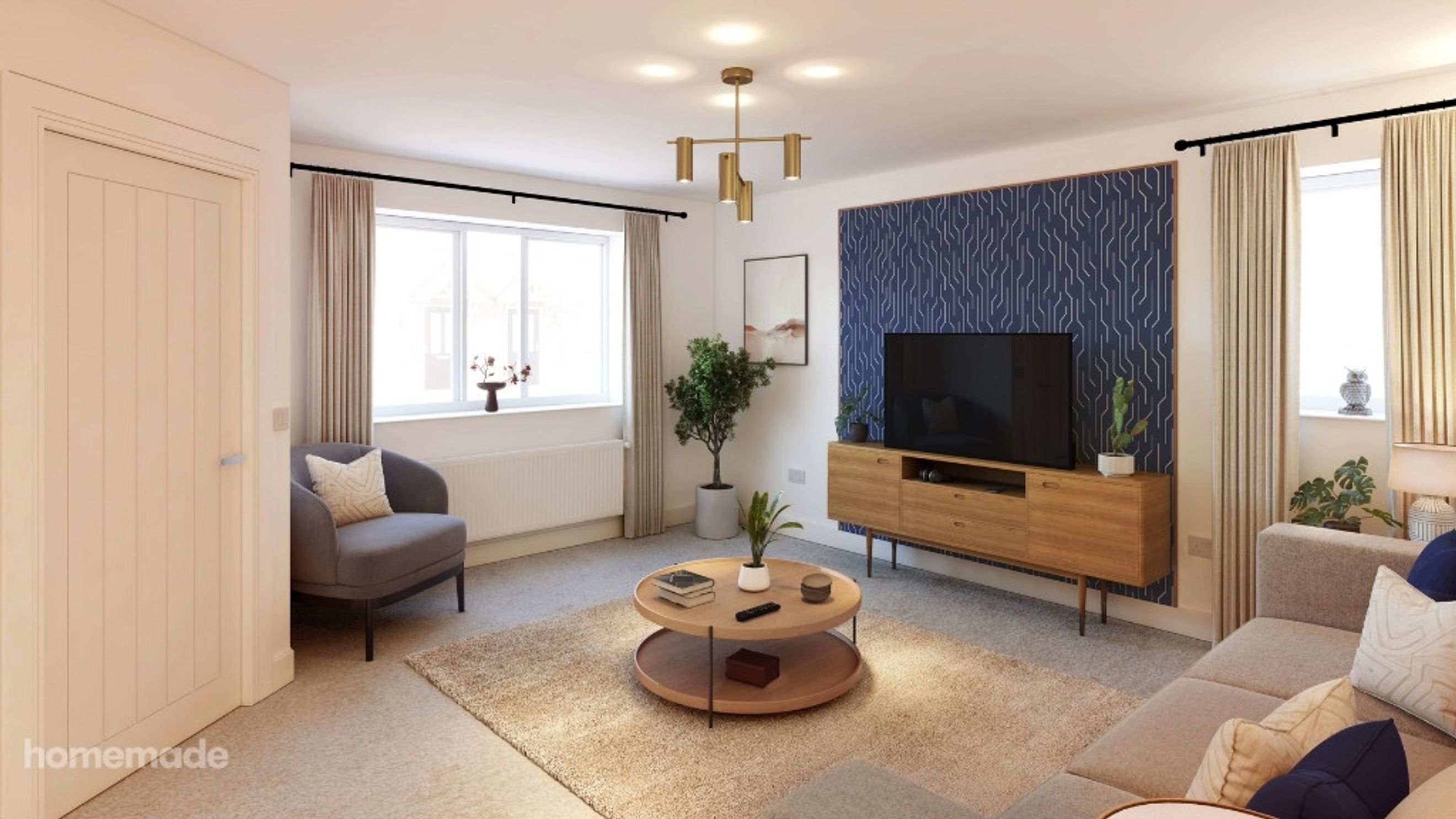 A living room with a television, media console, coffee table, sofa, and armchair.