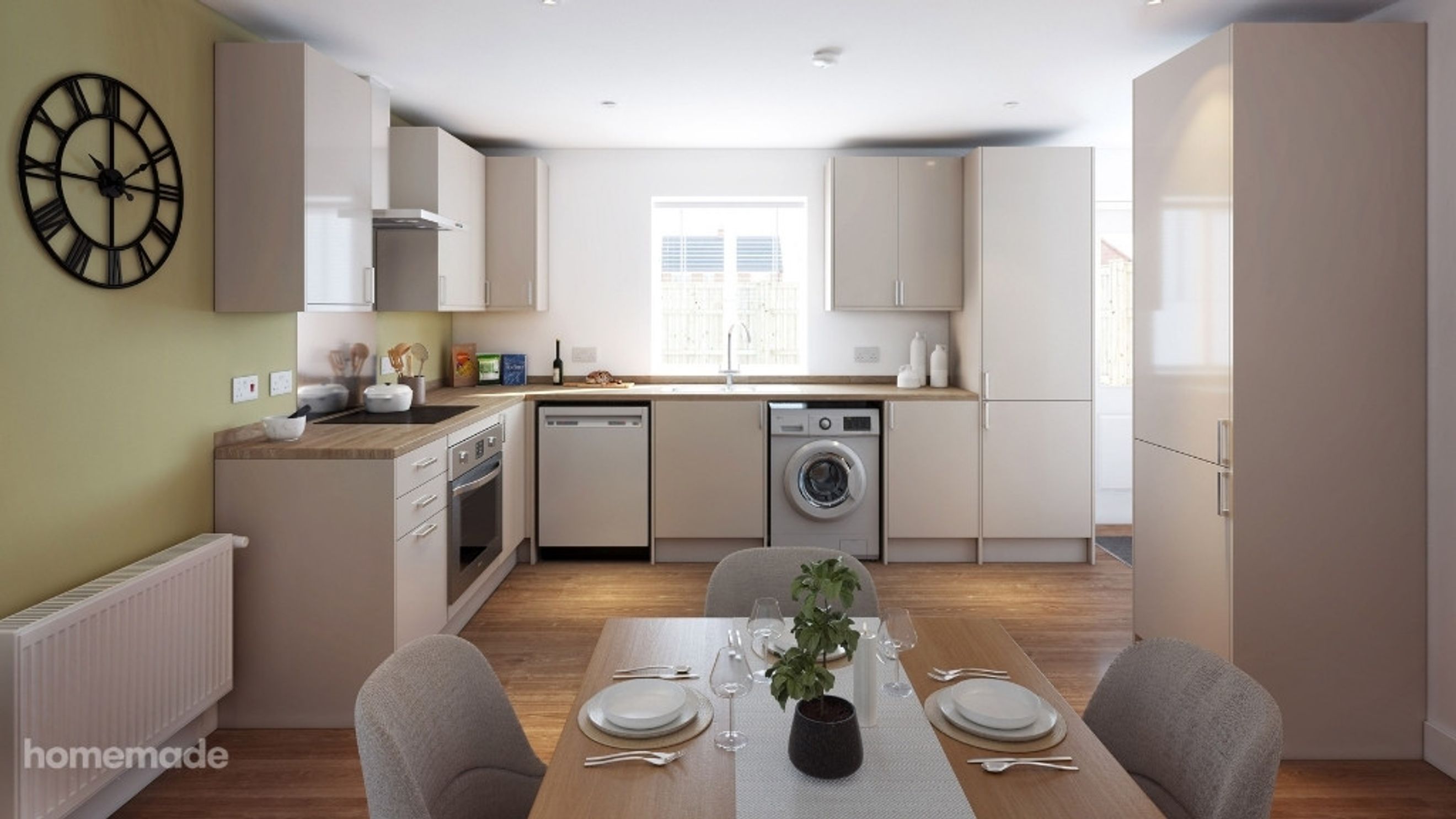 A modern kitchen with light-colored cabinets, integrated appliances, and a dining table.