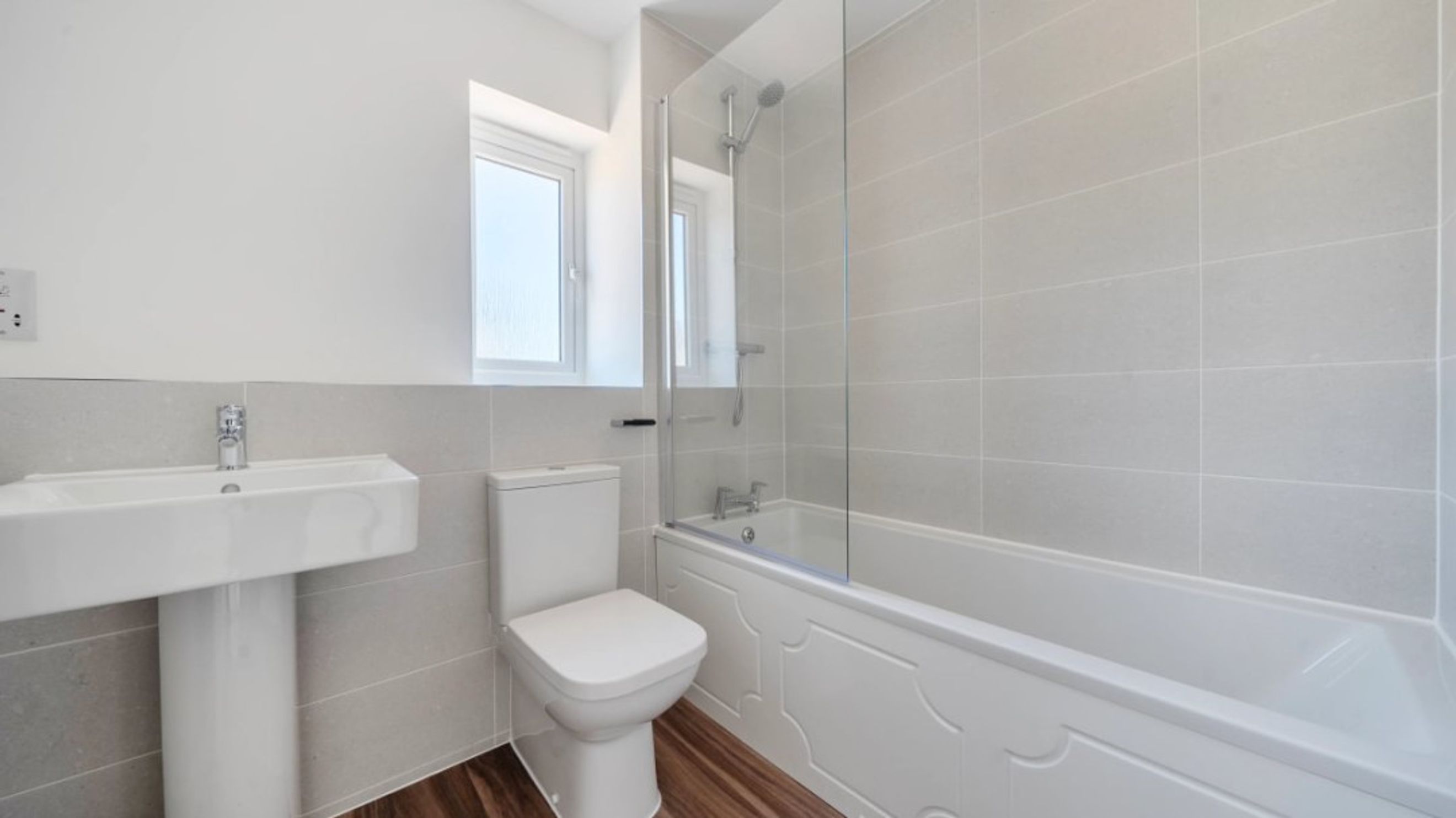 A bathroom with a sink, toilet, and bathtub.