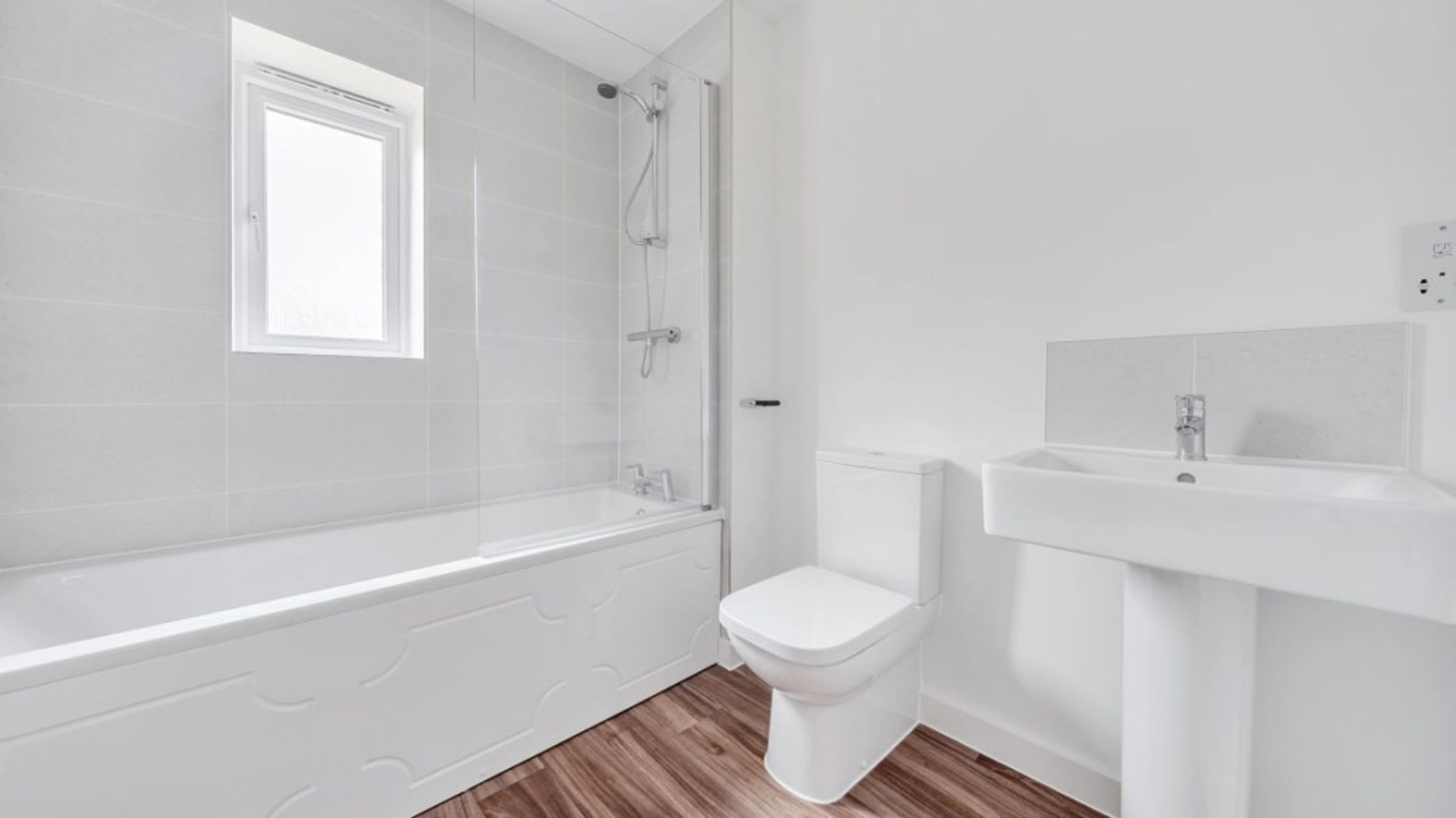 A bathroom with a bathtub, shower, toilet, and sink.