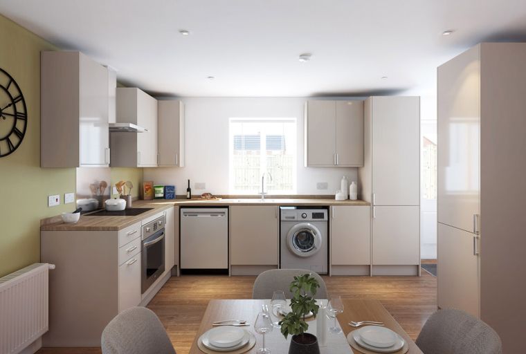 A modern kitchen with light-colored cabinets, a sink, a dishwasher, and a washing machine.