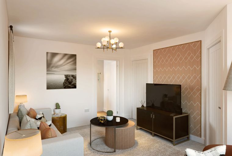 A living room with a sofa, coffee table, television, and a chandelier.