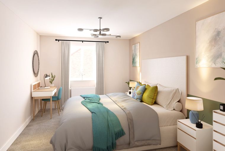 A bedroom with a bed, desk, chair, and a mirror.